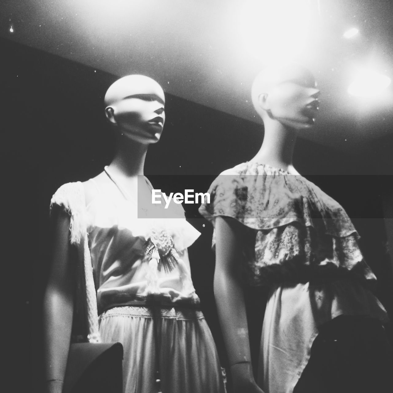 Low angle view of mannequins at store window