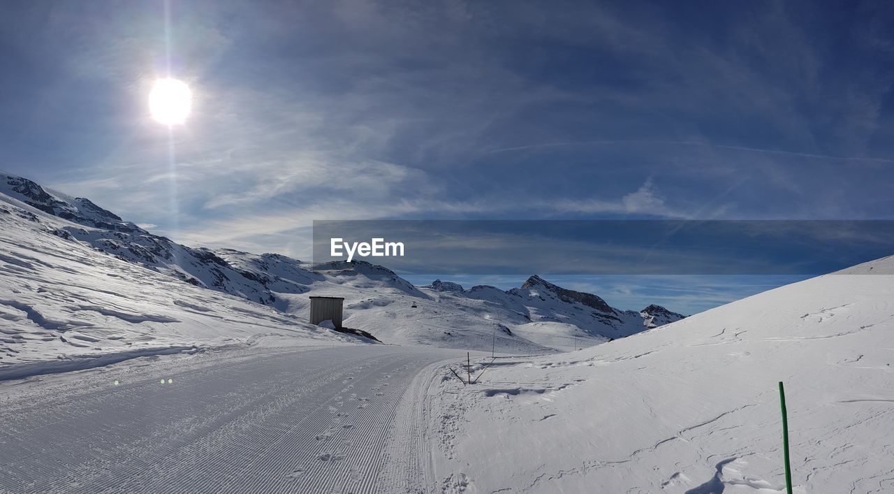 Scenic view of snow covered mountains against sky