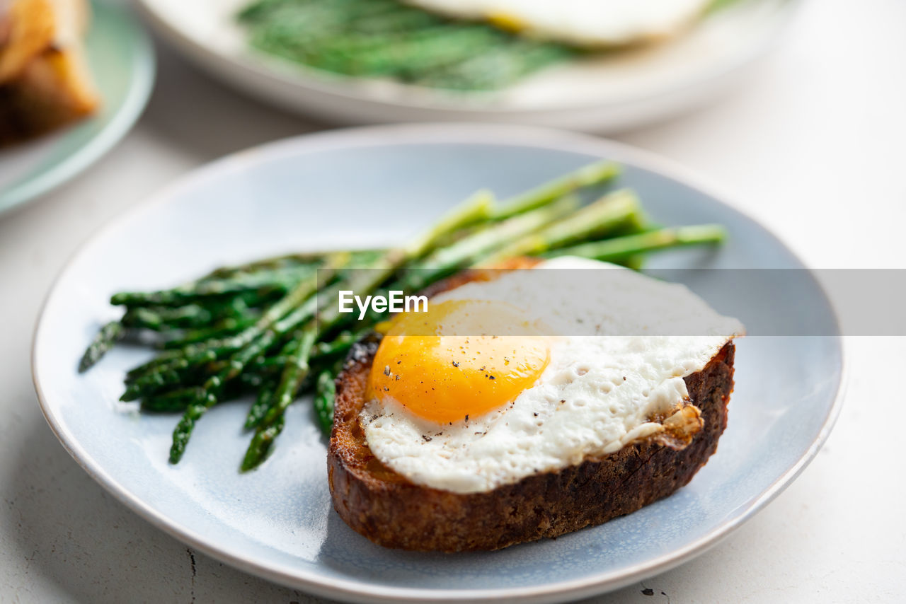 food, food and drink, healthy eating, egg, meal, plate, wellbeing, fried, dish, vegetable, bread, breakfast, freshness, fried egg, produce, toasted bread, no people, egg yolk, indoors, close-up, sunny side up, cuisine, meat, savory food, green