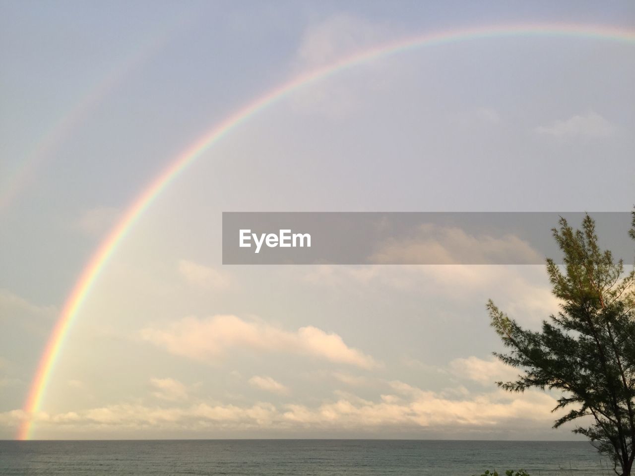 SCENIC VIEW OF RAINBOW OVER SEA