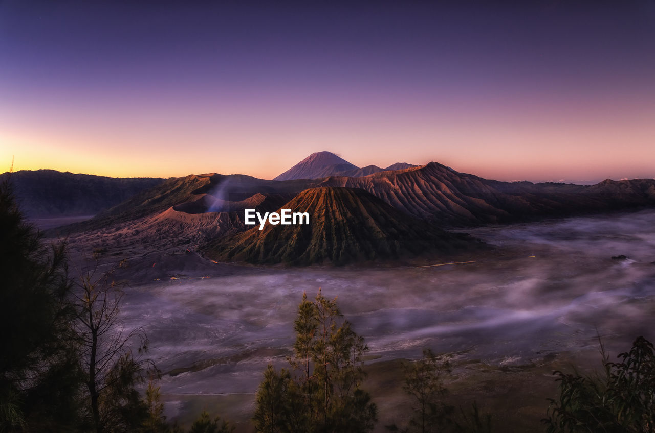 Panoramic view of volcanic landscape against sky during sunset