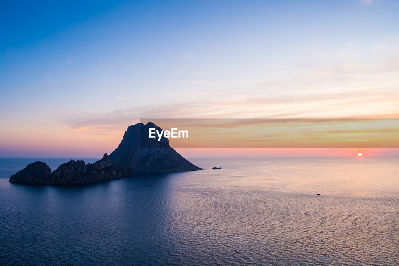 Ibiza, spain august 31 2019, sunset over sea from ibiza with es vedrà island