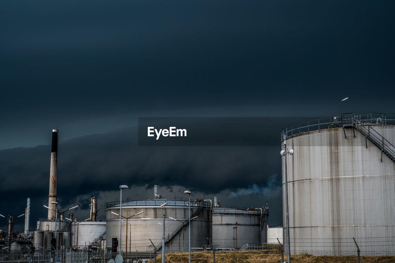 Storm clouds over crossbridge energy fredericia refinery, denmark