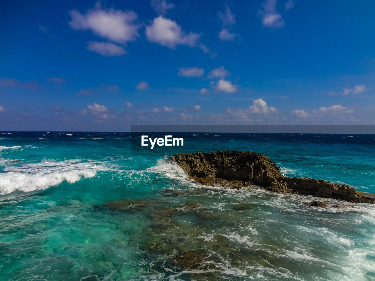 Scenic view of sea against blue sky