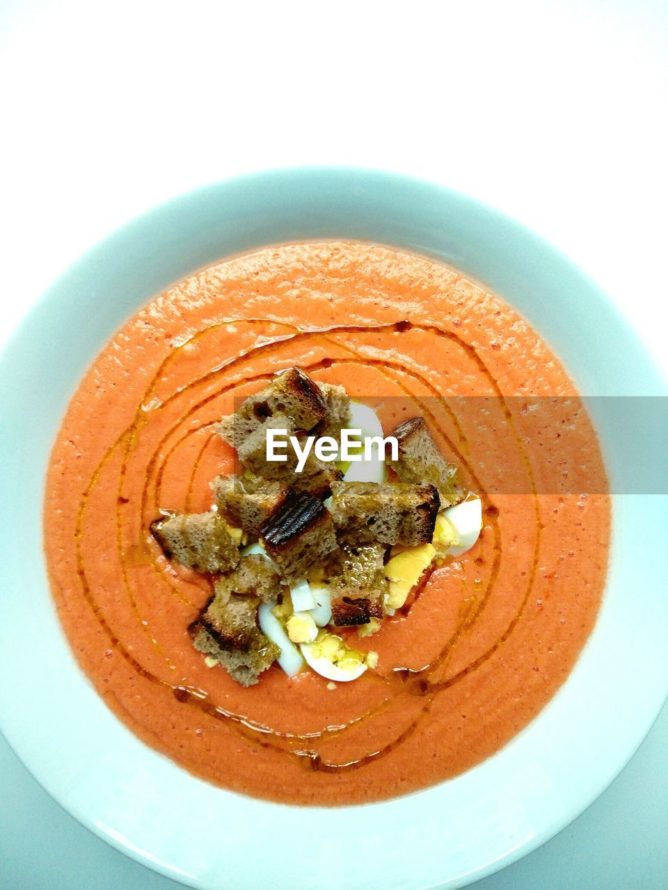 Directly above shot of salmorejo in bowl on white background