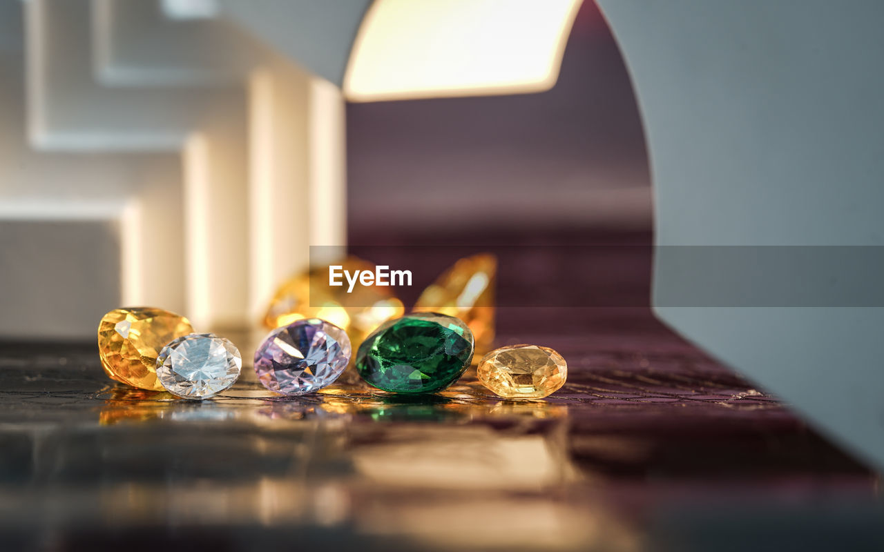 yellow, wealth, indoors, luxury, jewelry, selective focus, no people, gold, shiny, table, still life, diamond, close-up, precious gem, fashion accessory, gemstone, celebration, ring