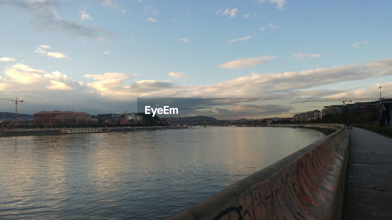 DISTANT VIEW OF BRIDGE OVER RIVER AGAINST SKY