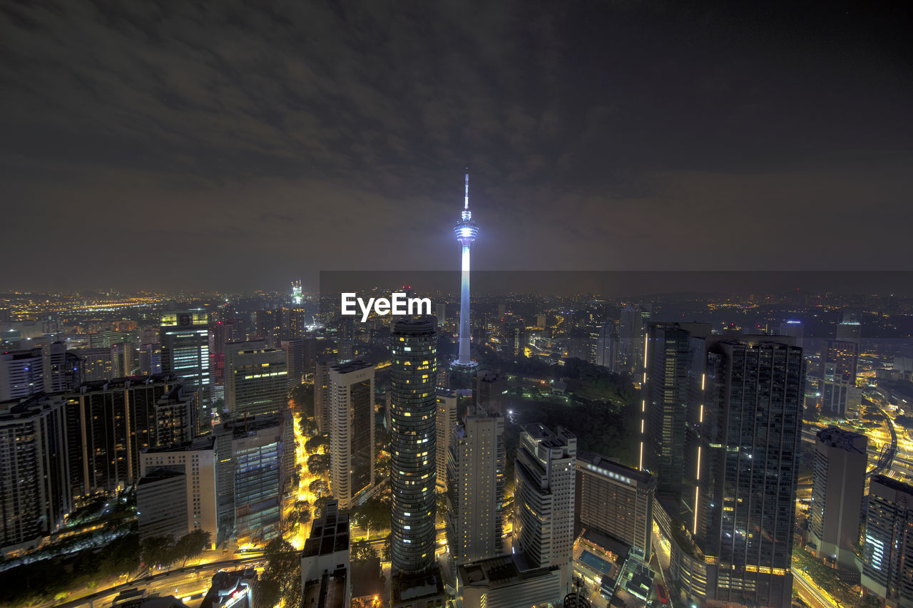 HIGH ANGLE VIEW OF ILLUMINATED BUILDINGS AGAINST SKY