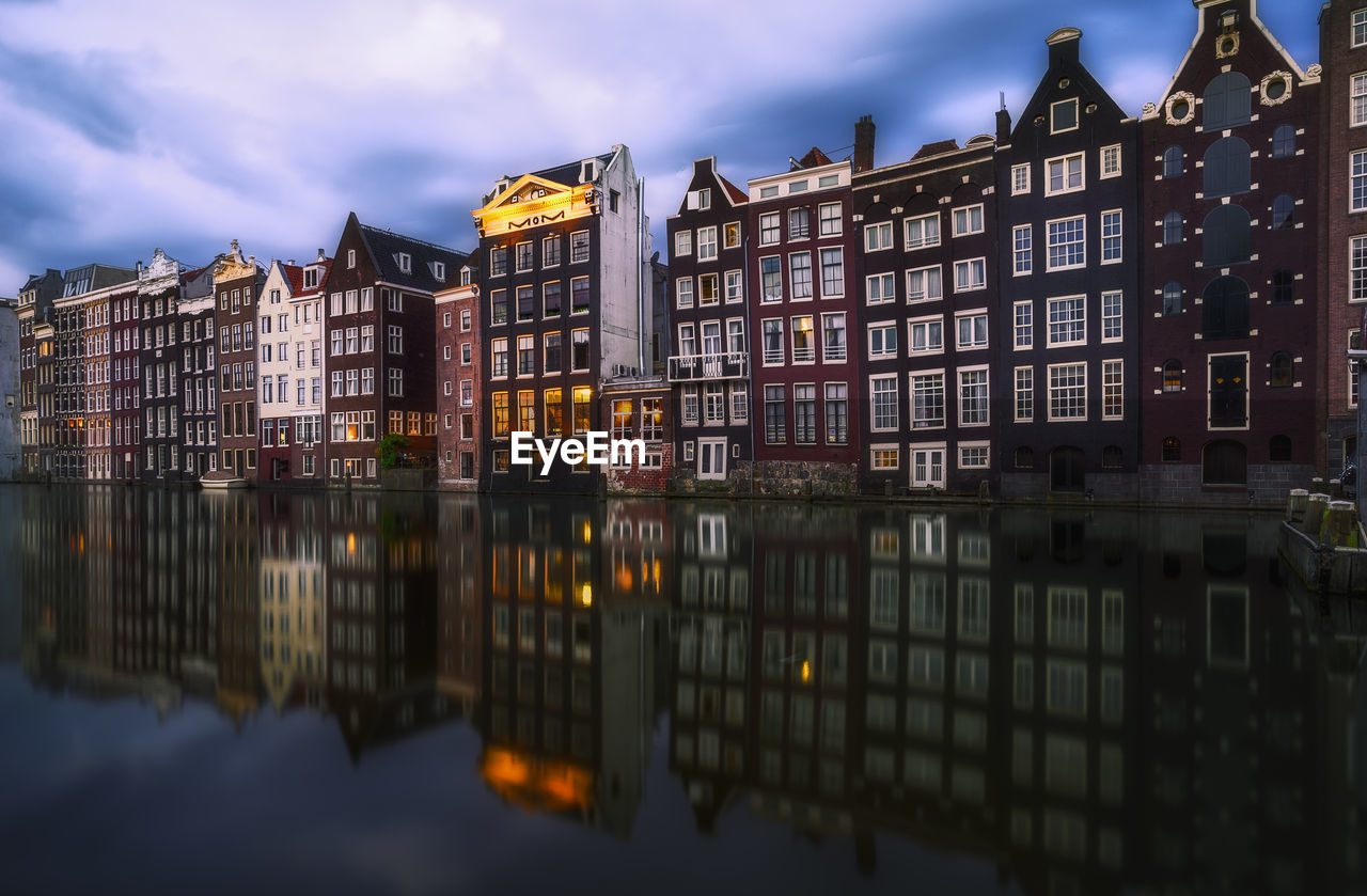 Reflection of buildings on river in city