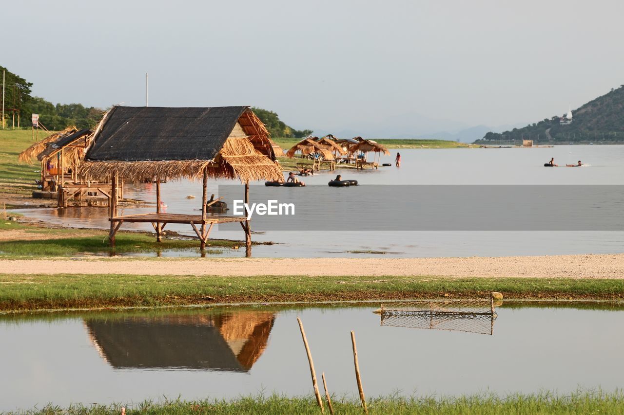 Scenic view of lake by building against sky