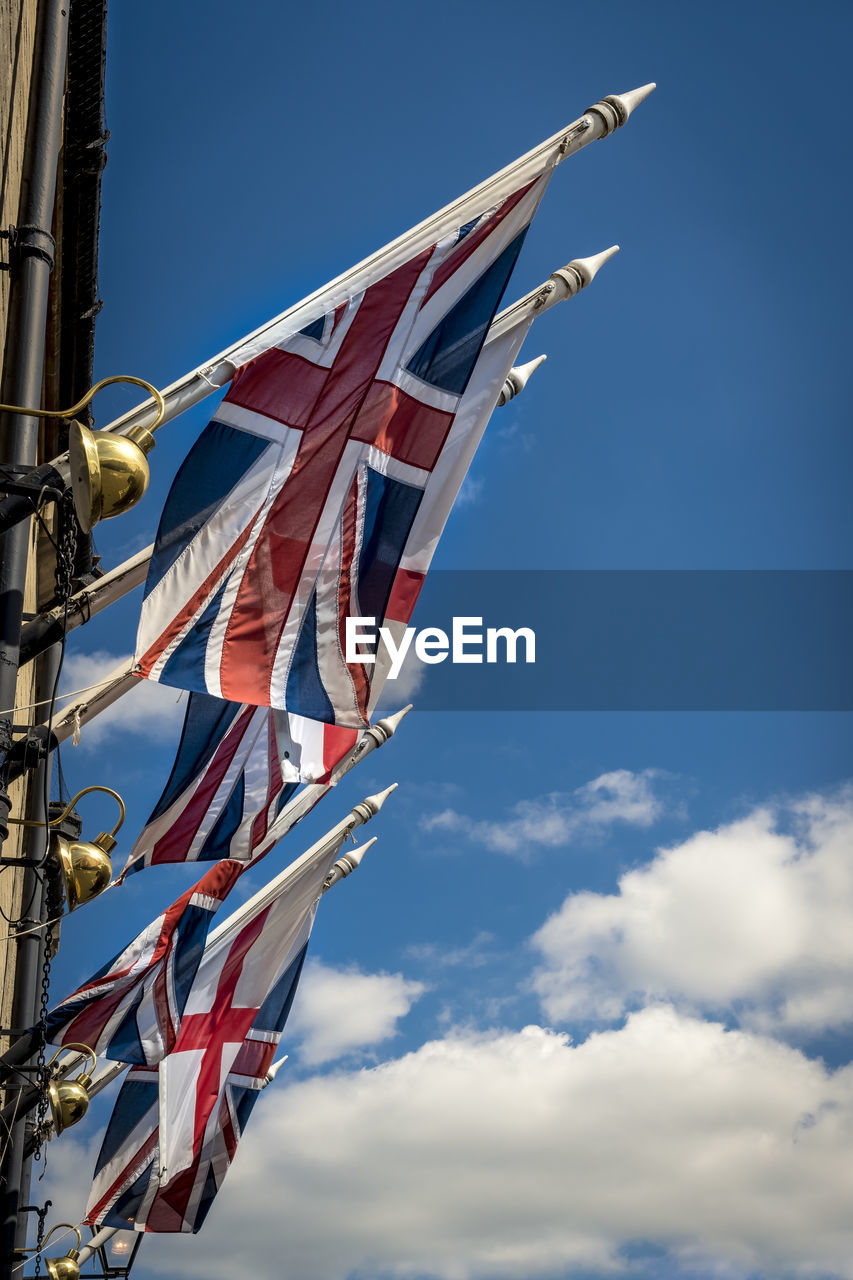 LOW ANGLE VIEW OF FLAGS AGAINST SKY