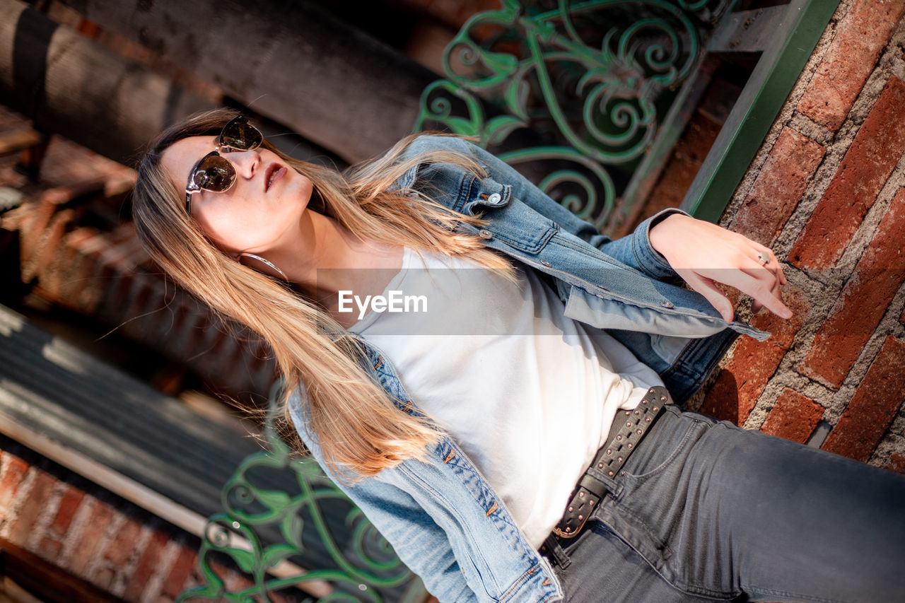 Young woman wearing casual clothing on the street. beautiful blond hair woman on the street.