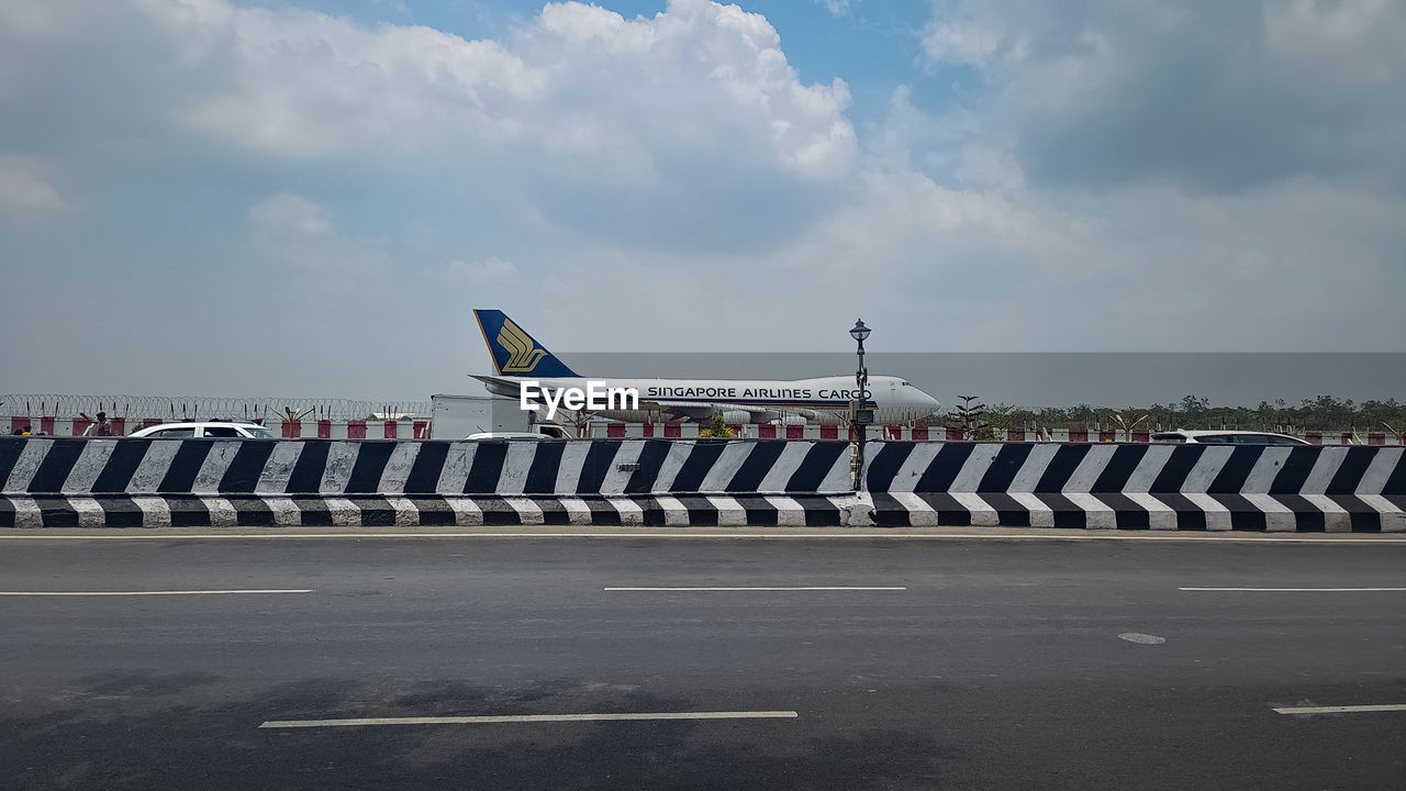 transportation, airplane, air vehicle, sky, vehicle, aviation, mode of transportation, cloud, airliner, air force, aircraft, airport, in a row, day, road, military, tarmac, airport runway, nature, infrastructure, outdoors, travel, government, jet aircraft, architecture