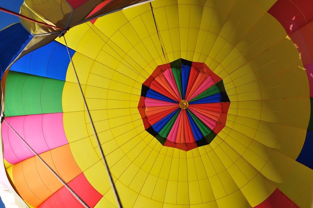 LOW ANGLE VIEW OF MULTI COLORED BALLOONS