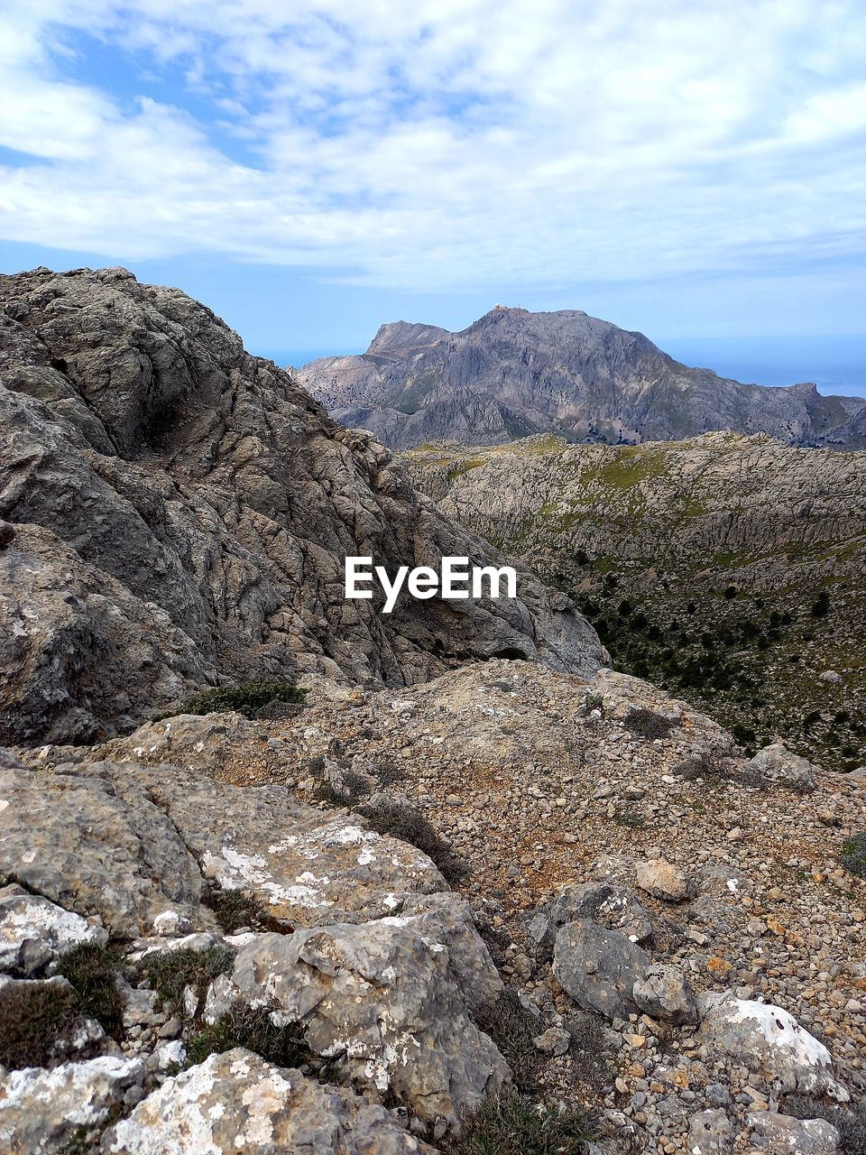 mountain, wilderness, landscape, environment, sky, cloud, scenics - nature, ridge, rock, nature, beauty in nature, adventure, land, walking, non-urban scene, geology, no people, day, mountain range, tranquility, outdoors, trail, tranquil scene, travel destinations, rock formation, volcano, plant, physical geography, travel, extreme terrain, remote