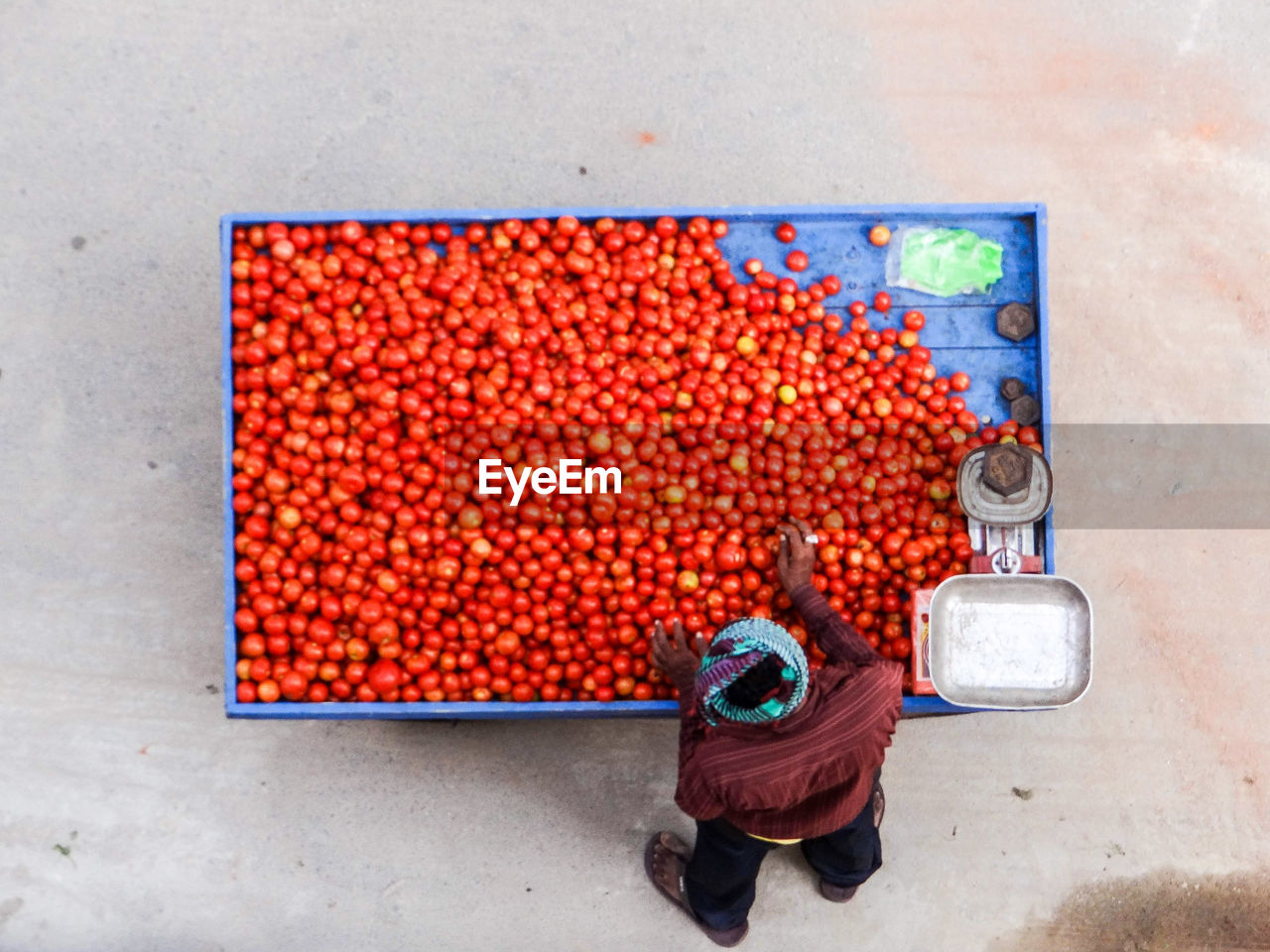 High angle view of person selling tomatoes