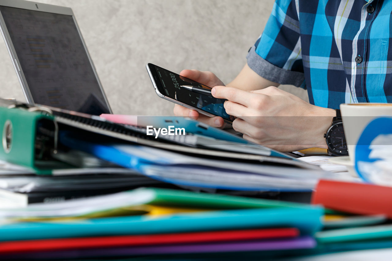 CLOSE-UP OF PERSON USING LAPTOP