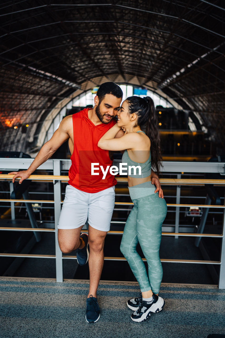 Portrait of young couple in love having a special moment in gym clothes