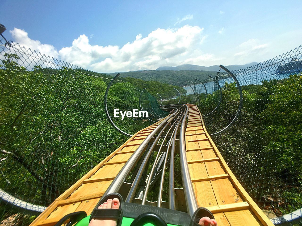 Cropped image of human foot on rollercoaster
