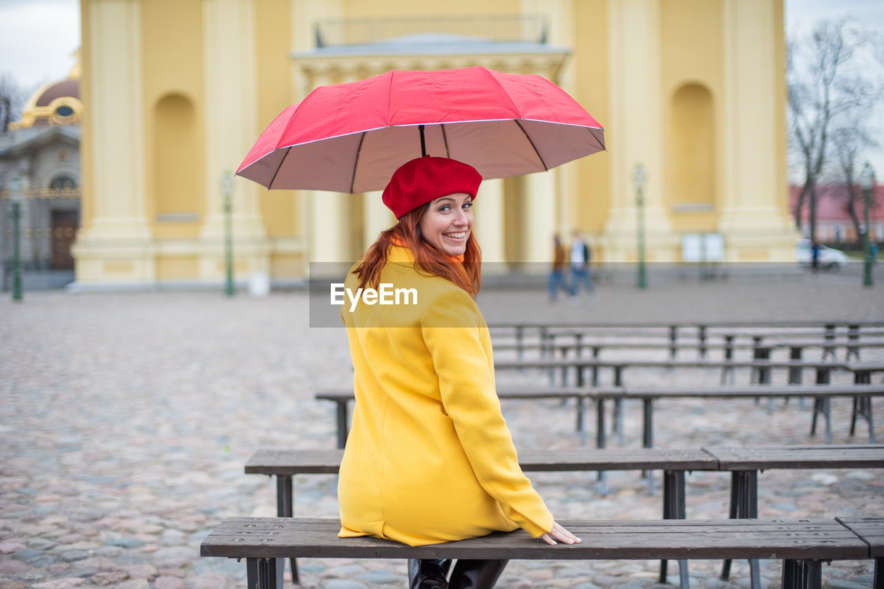 Portrait of woman with umbrella in rain