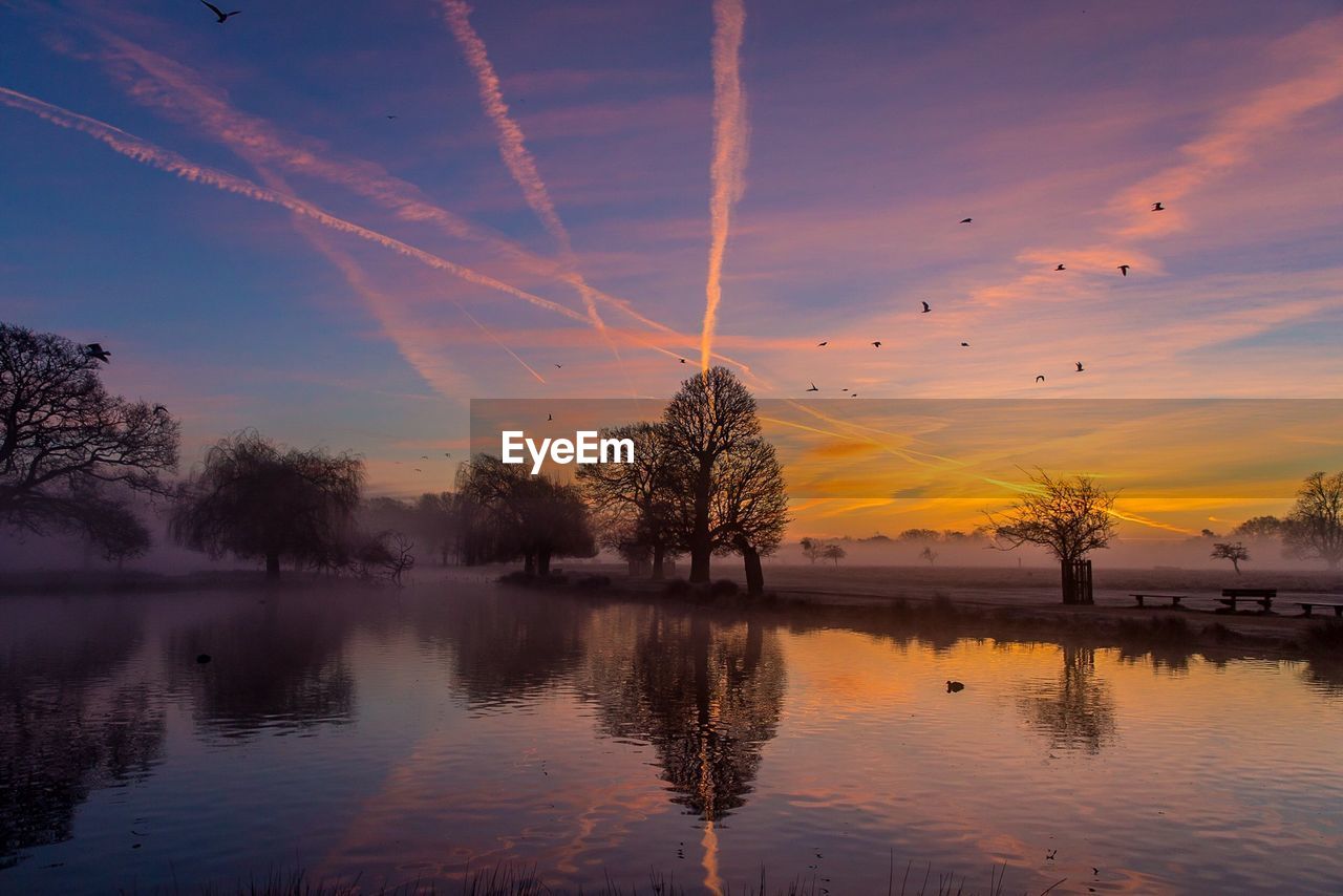 Scenic view of lake against sky during sunset