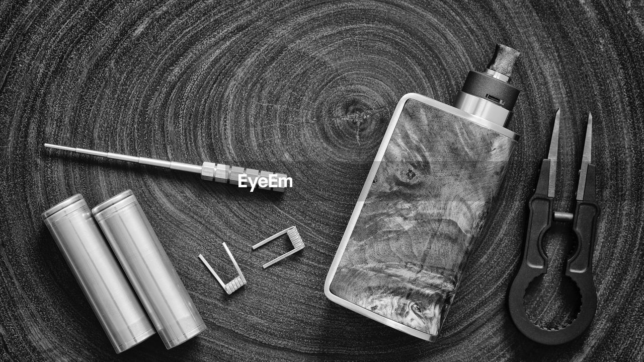 HIGH ANGLE VIEW OF OLD CIGARETTE ON TABLE WITH BAG