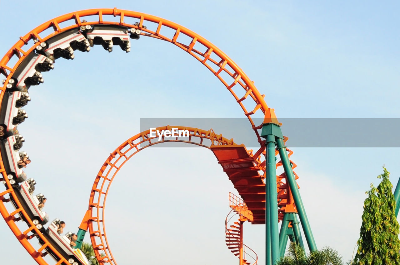 Low angle view of rollercoaster against sky