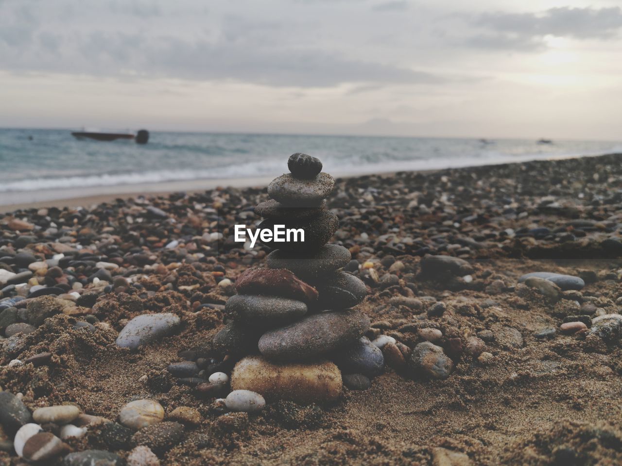 Pebbles on beach against sky