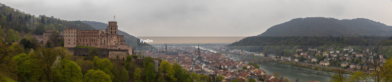 Aerial view of the old town and the old Karl Theodor bridge over the Neckar river and the ruis of the castle, Heidelberg, Baden-Wuerttemberg, Germany Scenic Scene Roof Romantic River Panorama Old Monument Medieval Landscape Landmark Historic Hill Fortress Forest Famous Downtown Destination Cityscape City Church Château Cathedral Castle Building Bridge Beautiful Baroque Attraction Architecture Aerial Rhine Neckar Heidelberg Germany German European  Europe Baden-Württemberg  Baden-Wuerttemberg