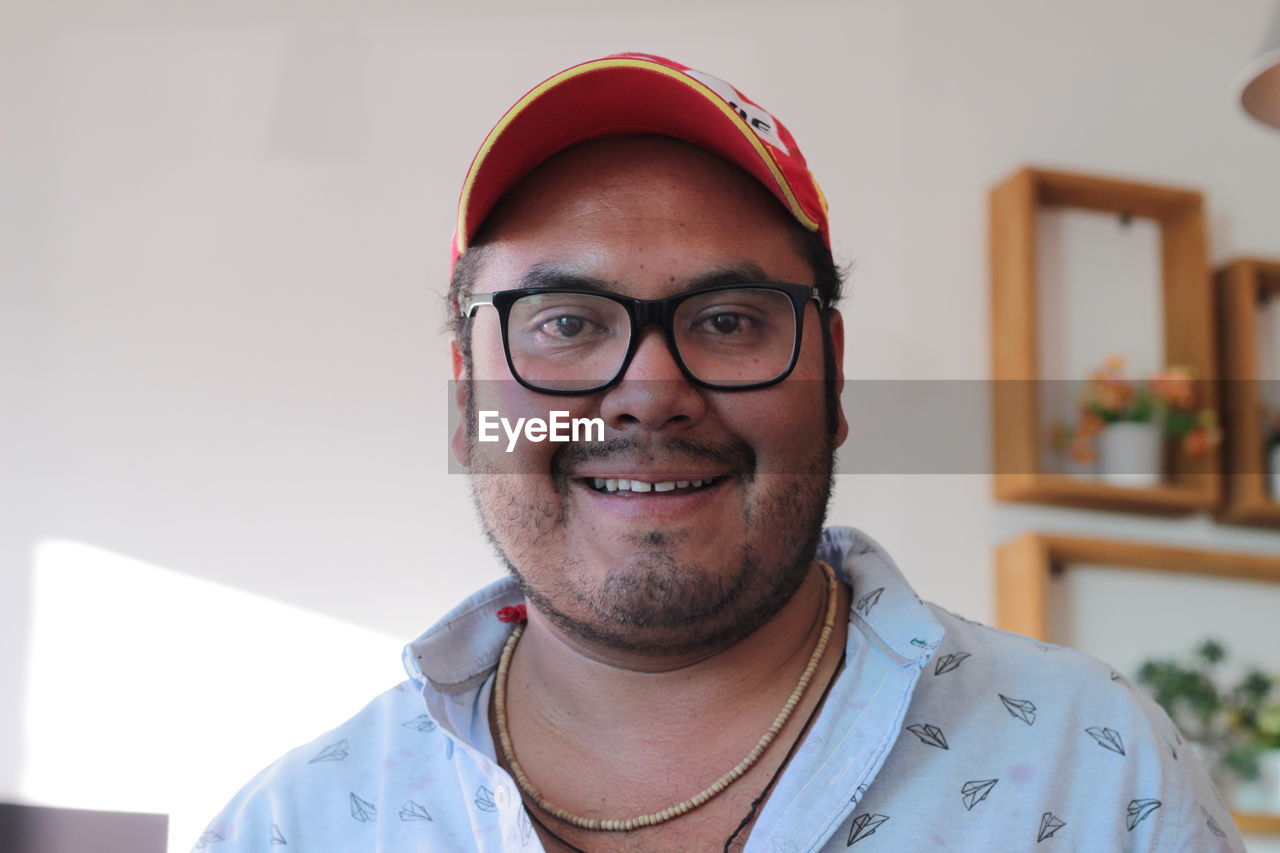 Portrait of man in cap at home