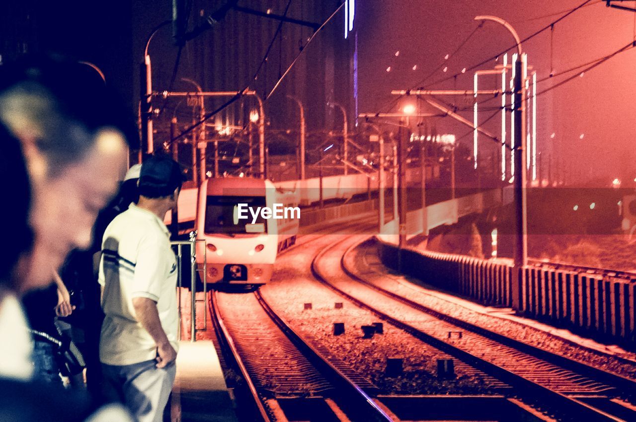 TRAIN AT RAILROAD STATION PLATFORM AT NIGHT