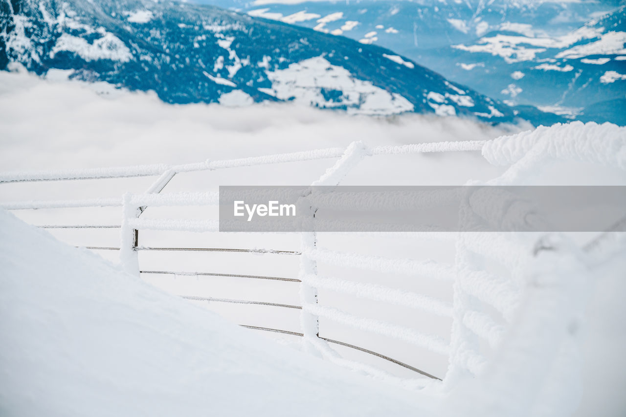 Fence on snow covered mountain