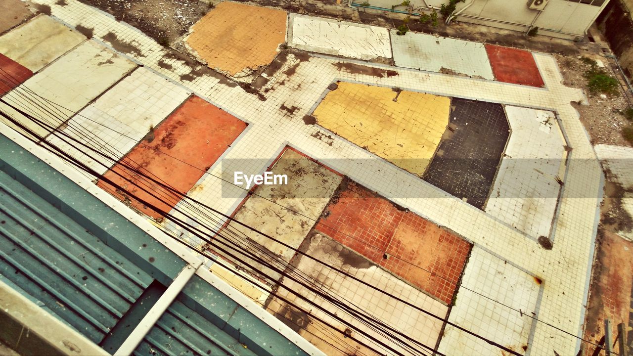 High angle view of damaged abandoned tiles