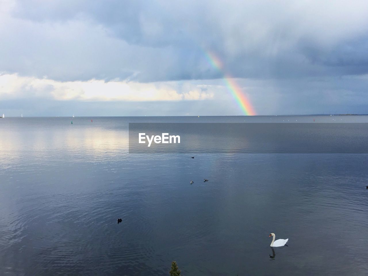 Scenic view of rainbow over sea against sky