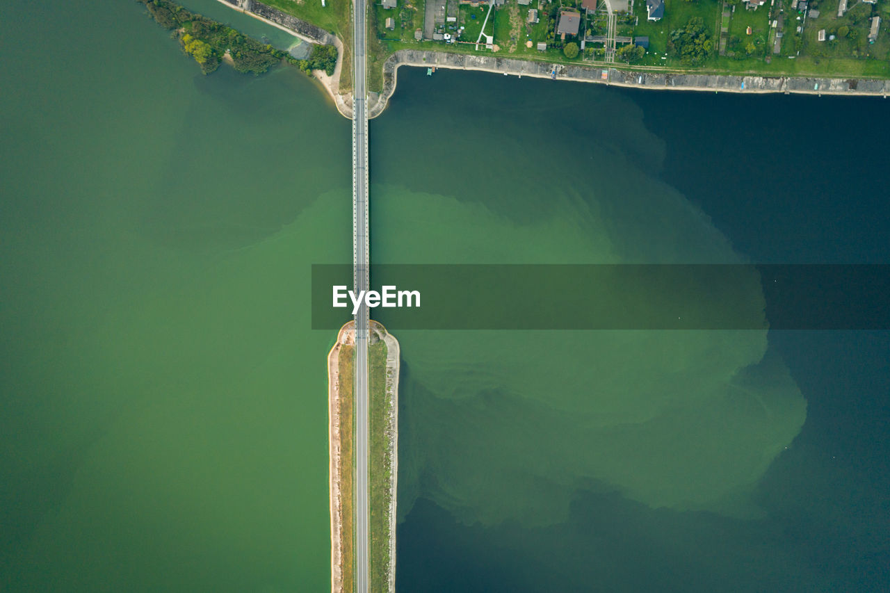 Aerial drone photo of modern bridge crossing deep blue lake. abstraction.