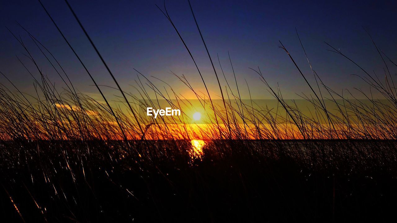 SILHOUETTE LANDSCAPE AGAINST SKY DURING SUNSET