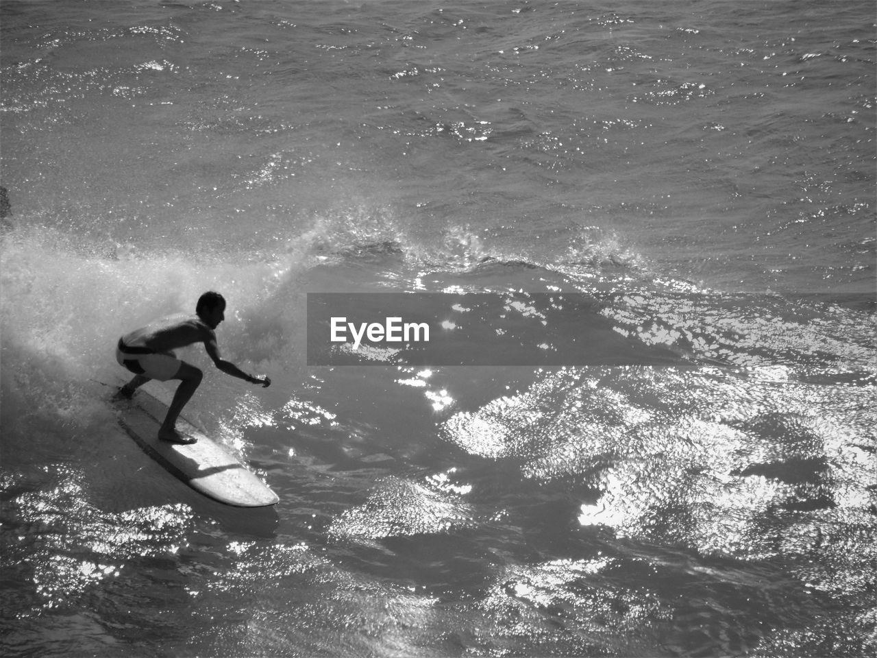 Man surfing on waves in sea