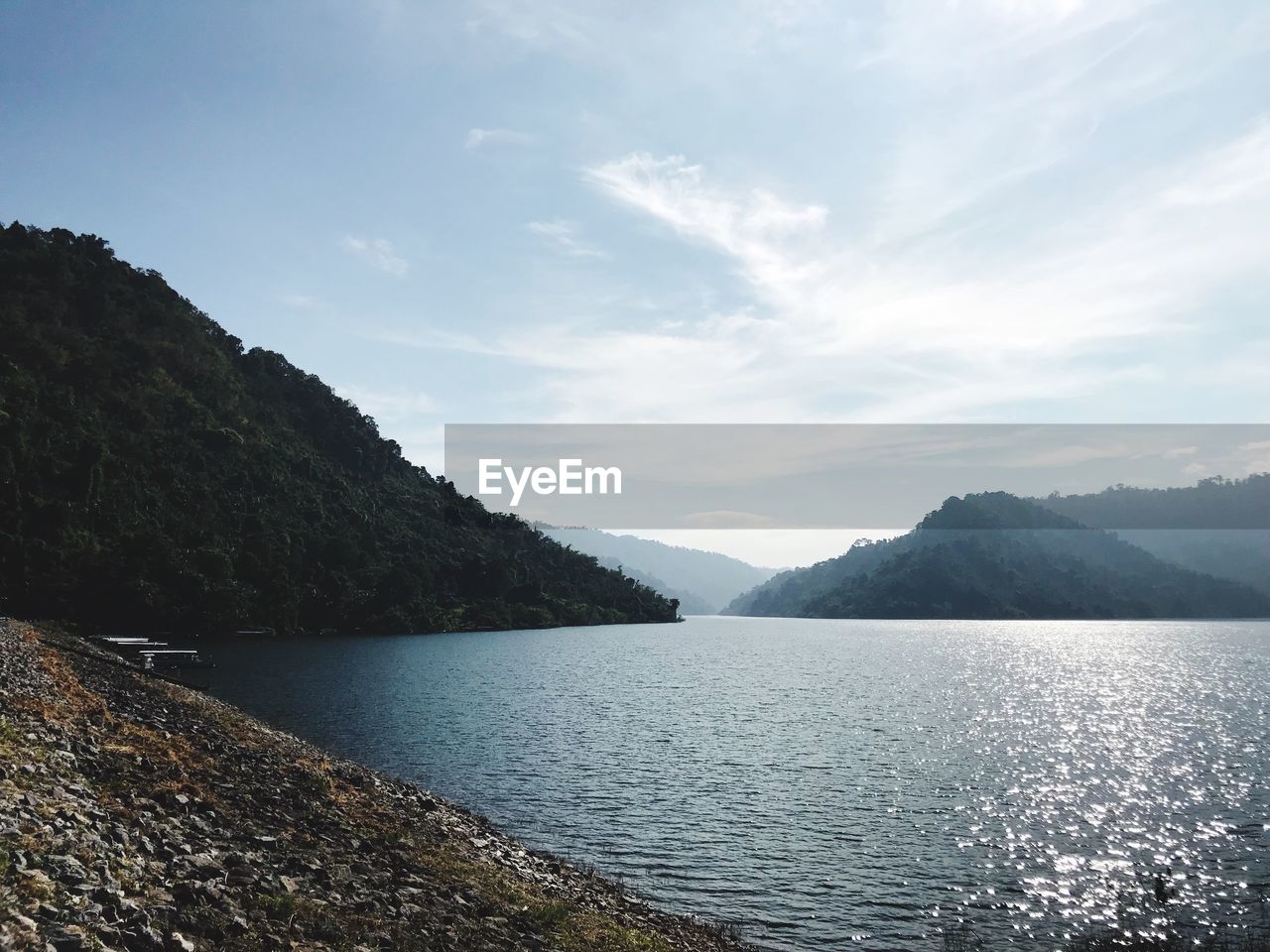 Scenic view of lake and mountains against sky