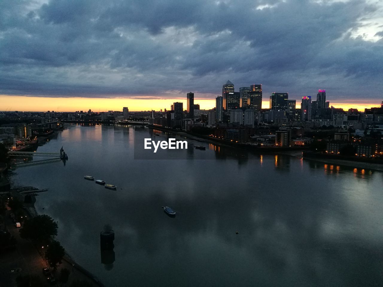 View of city lit up at sunset