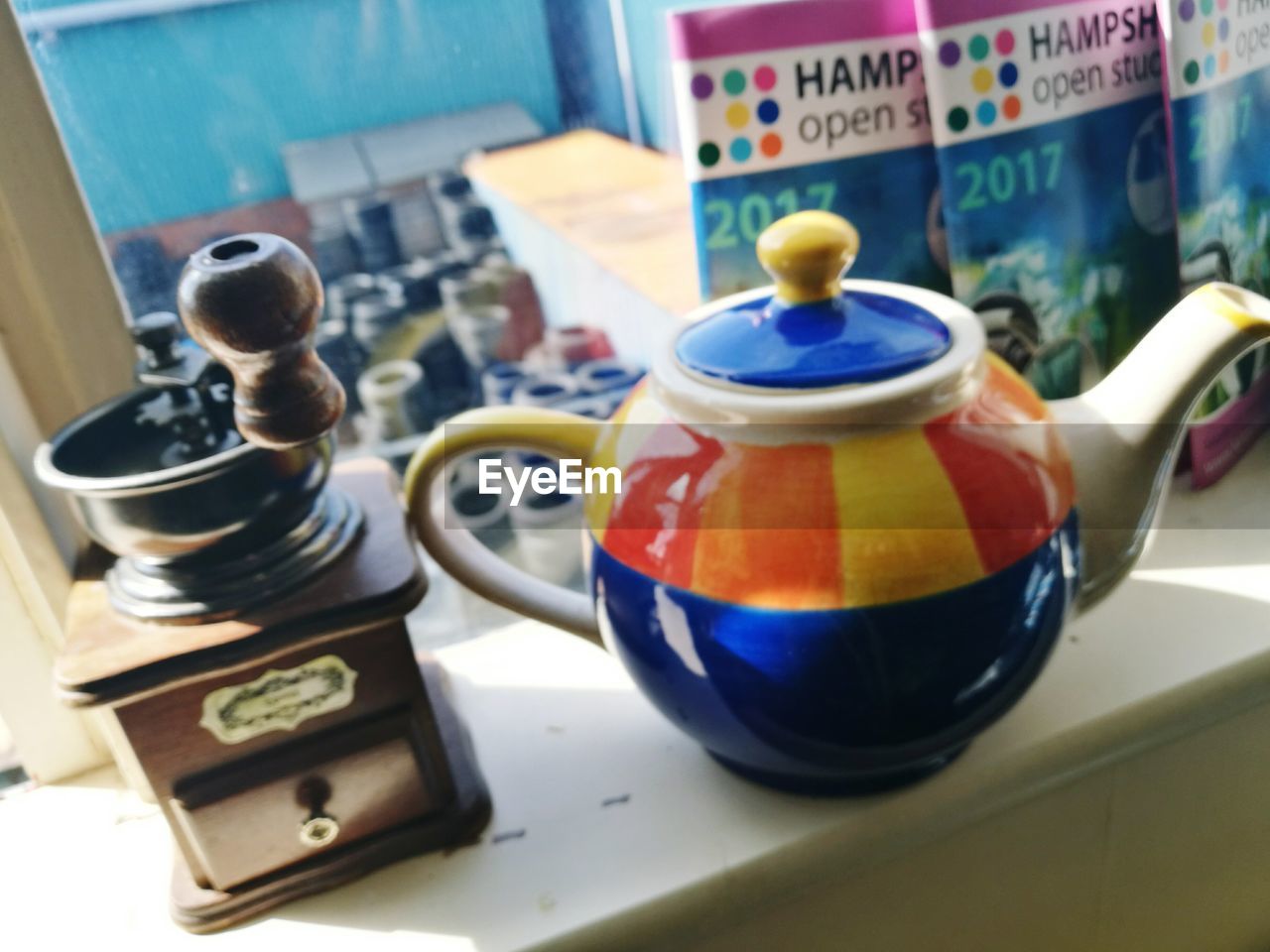 CLOSE-UP OF MULTI COLORED TEA ON TABLE