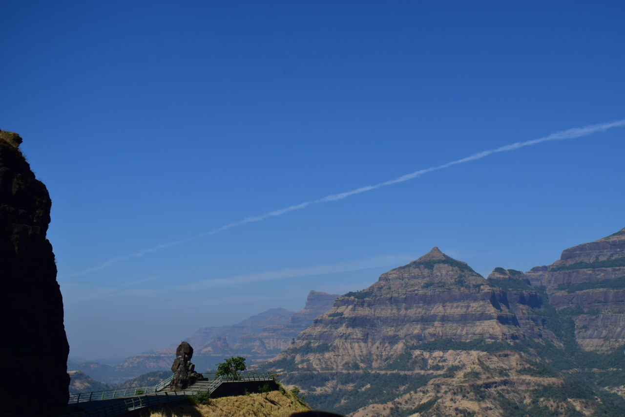 VIEW OF CASTLE AGAINST MOUNTAIN RANGE