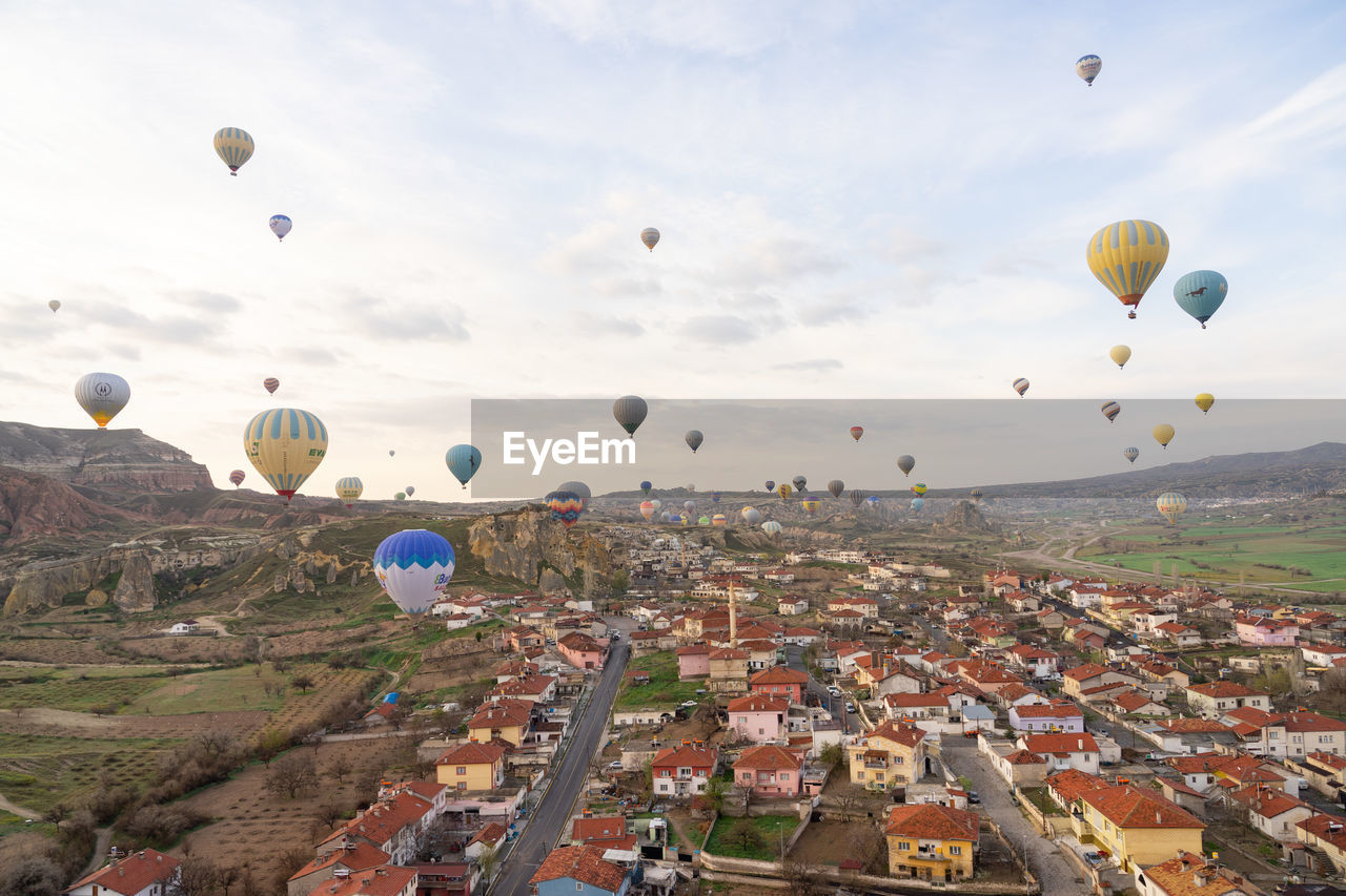 AERIAL VIEW OF HOT AIR BALLOON FLYING OVER LANDSCAPE