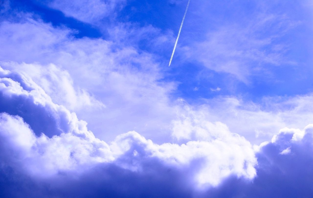 Vapor trail in cloudy sky