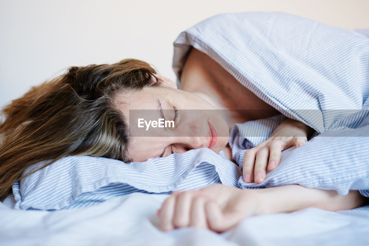 Woman sleeping in the bed at morning