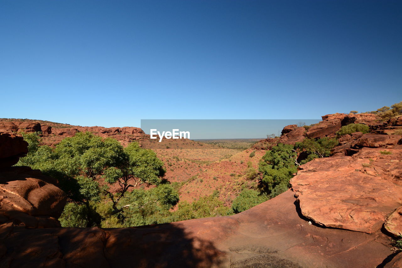 Scenic view of mountains against clear blue sky