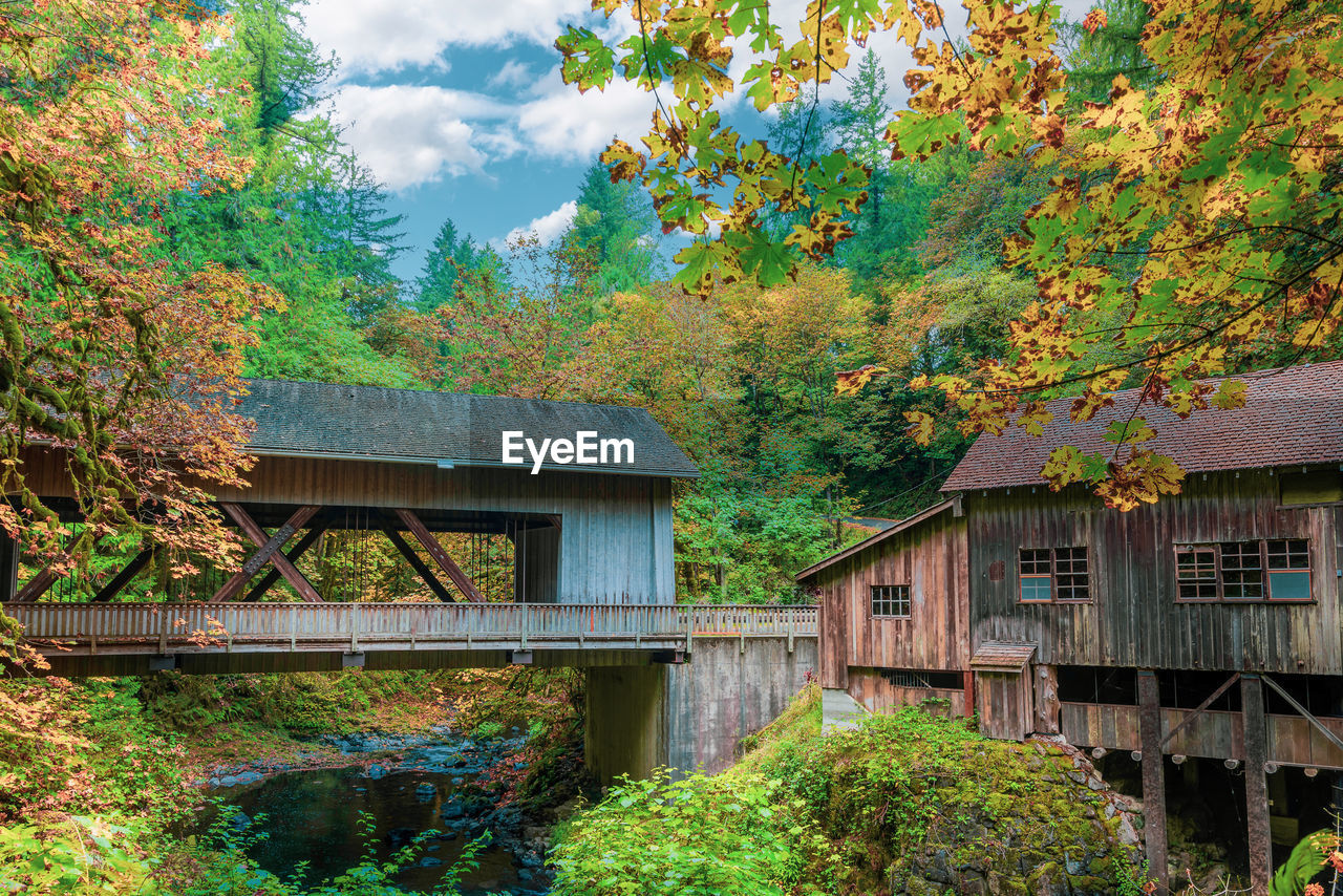 Covered bridge and grist mill with autumn foliage