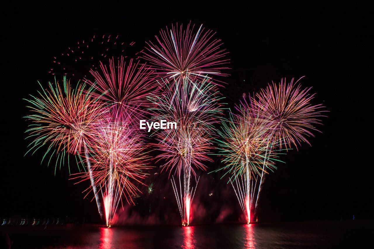 Low angle view of firework display at night