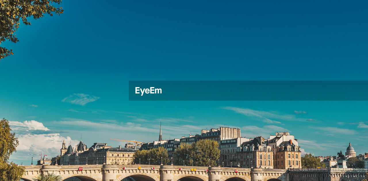 BUILDINGS AGAINST BLUE SKY IN CITY