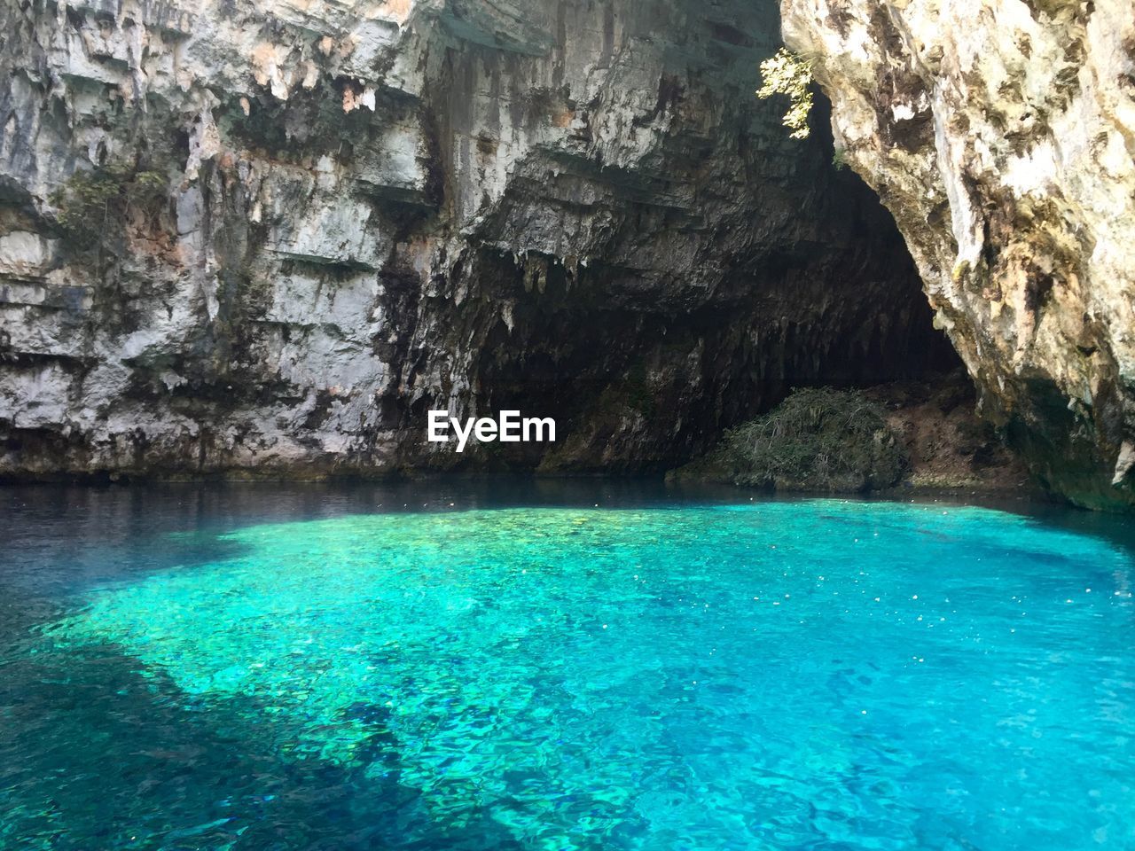 Idyllic view of turquoise sea against rock formations