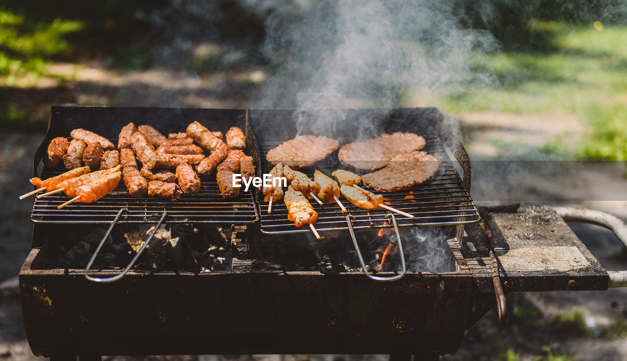 CLOSE-UP OF MEAT ON BARBECUE